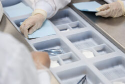 Sterilization process in a medical sterilizer with gloves and surgical tools.