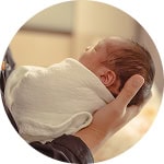 A baby being held gently, showcasing healthcare services at Canadian Hospital Specialties Ltd.