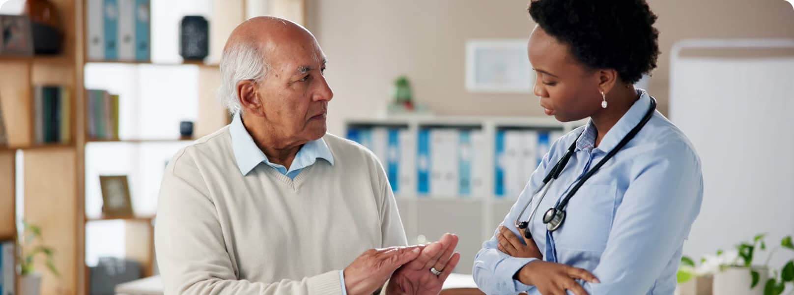 Healthcare professional consulting with elderly patient.