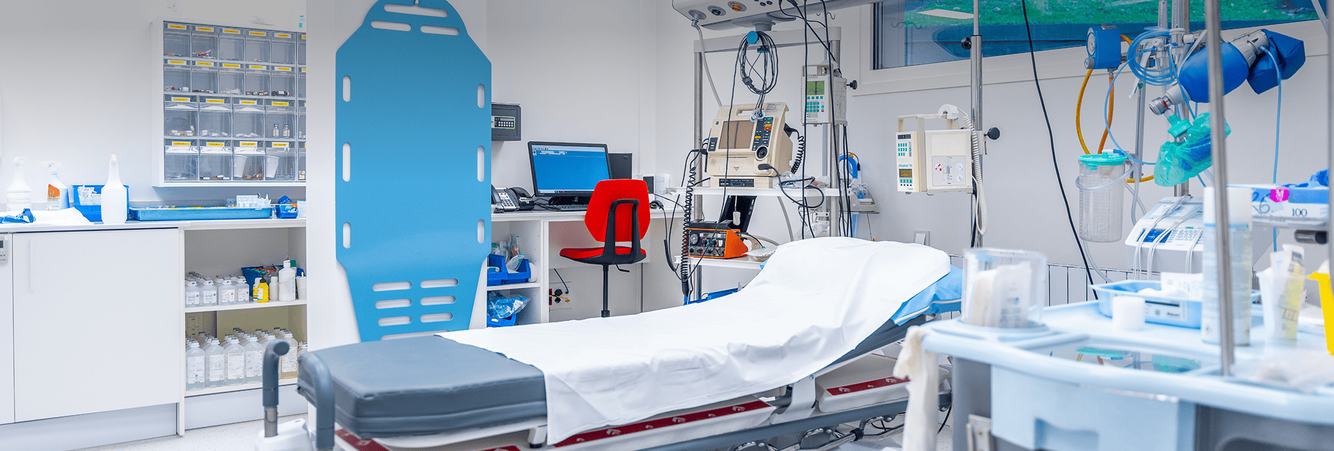 Modern hospital medical equipment and patient bed in a clinical setting.