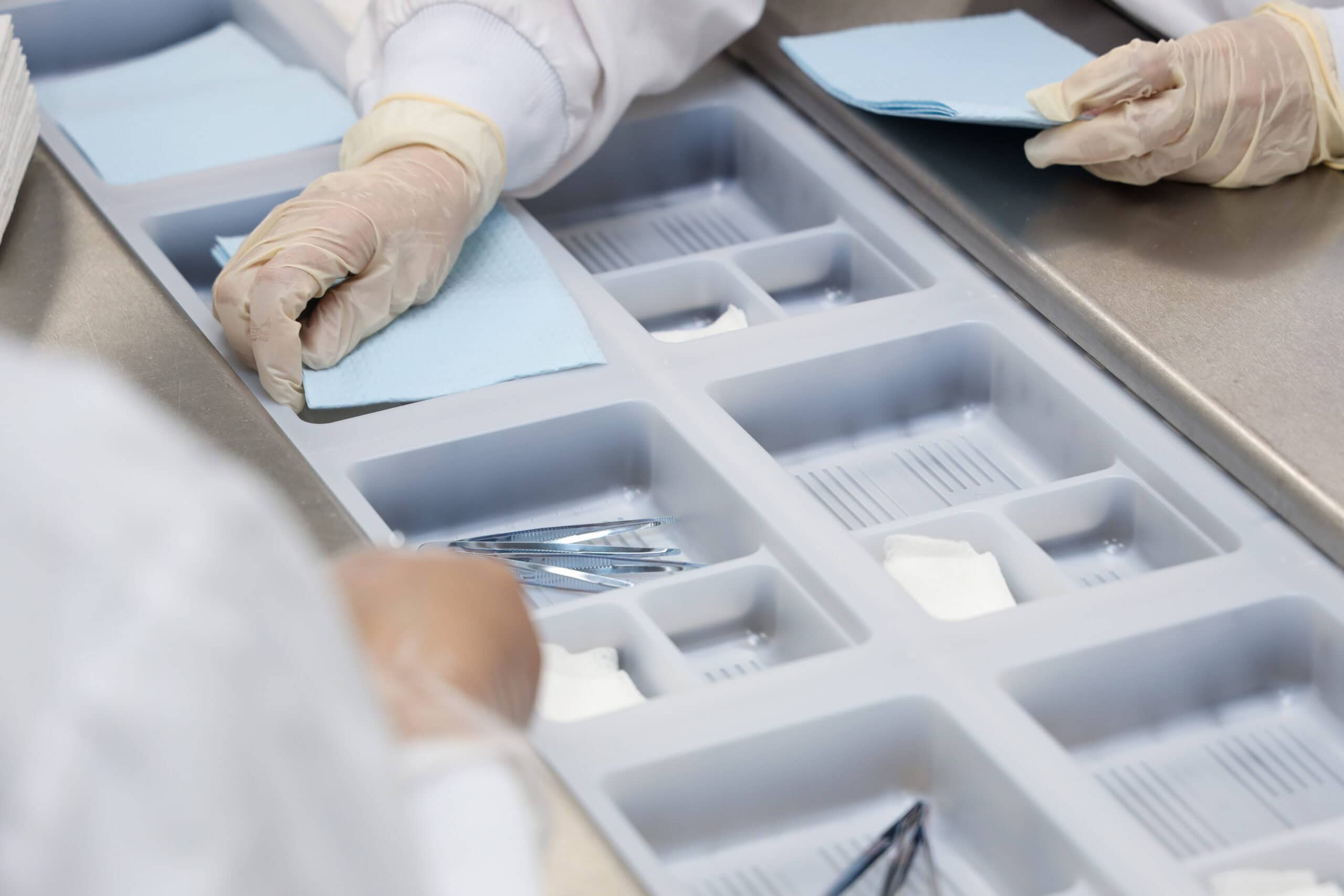 Sterilization process in a medical sterilizer with gloves and surgical tools.